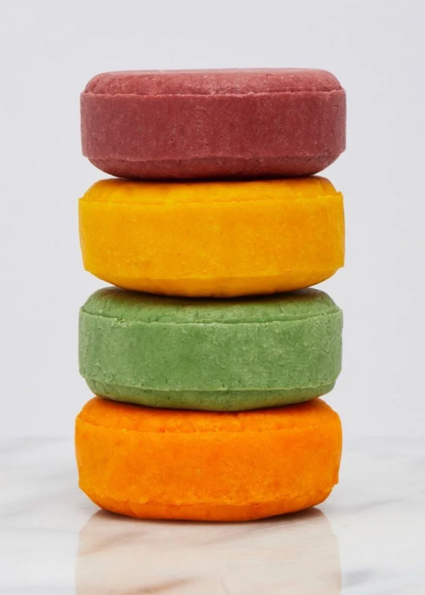 Stack of colorful round soaps on a light background