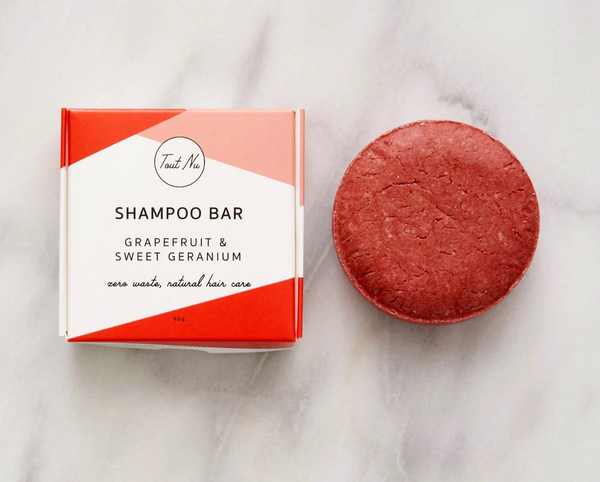 Shampoo bar with packaging on a marble surface