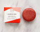 Shampoo bar with packaging on a marble surface